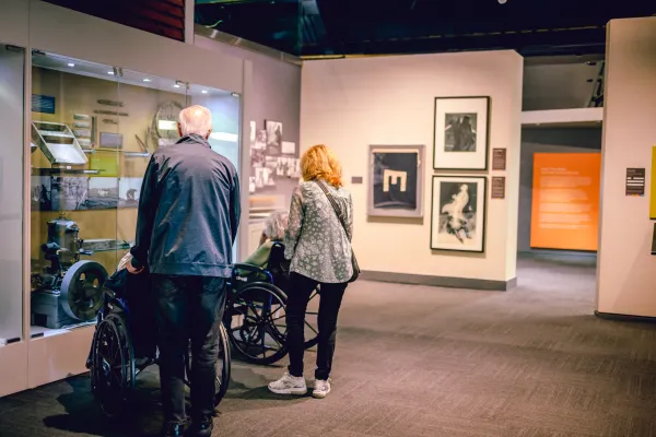 two seniors push two guests in wheelchairs